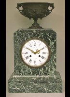 Green marble mantel clock with a bronze vase on top, signed 'Raingo Fr�res � Paris'.