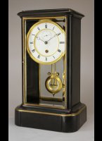 Black marble glass mantel clock by Achille Brocot with a year going movement and unusual temperature compensated pendulum (Ellicot style).
The movement has 5 serial connected barrels for the long duration. Full winding takes 80 half keyturns.

high: 49 cm
wide:  29 cm
deep:  22 cm
weight: 24 kg